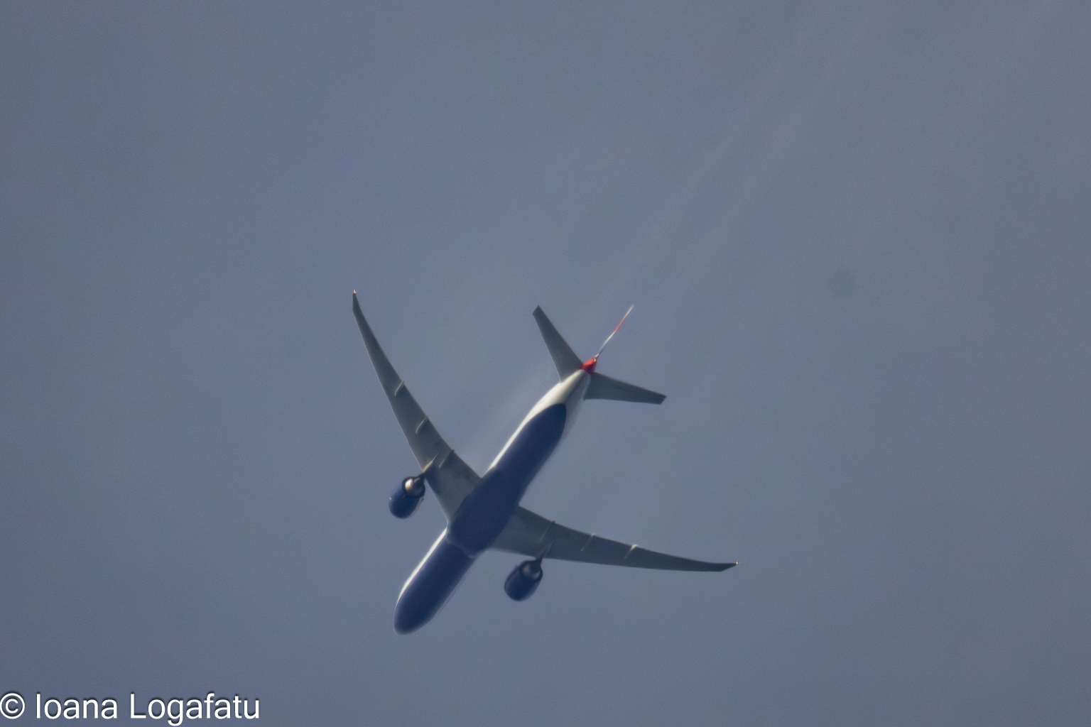 Airplane soaring through the bright blue sky